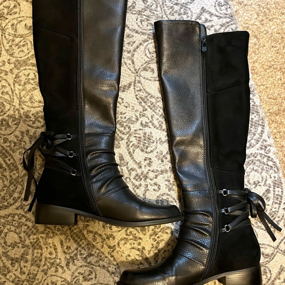 Sexy knee-high black boots. Lace up detailing, side zipper.